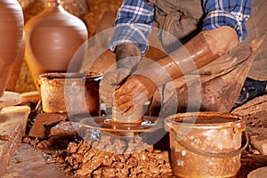 Professional potter making bowl in pottery workshop, studio