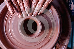 Professional potter making bowl in pottery workshop, studio