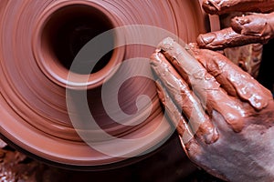 Professional potter making bowl in pottery workshop, studio