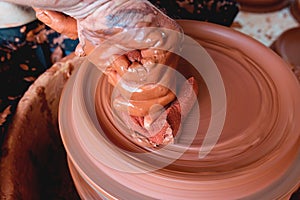 Professional potter making bowl in pottery workshop, studio