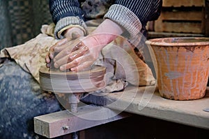 Professional potter making bowl in pottery workshop, studio