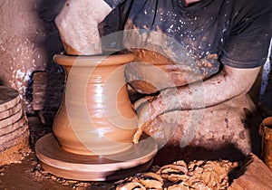 Professional potter making bowl in pottery workshop, studio