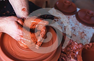 Professional potter making bowl in pottery workshop, studio. photo