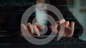 Professional programmer typing code on keyboard with computer screen in background displaying programming language