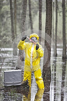 Professional in protective coveralls testing contaminated environment photo