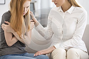 Professional psychologist comforting upset woman