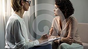 Professional psychologist listening depressed lady patient, break-up therapy