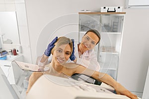 Professional radiologist doing mammogram x ray for young woman to check for breast cancer