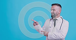 Professional recommendation. Smiling medical doctor pointing aside at copy space and nodding head