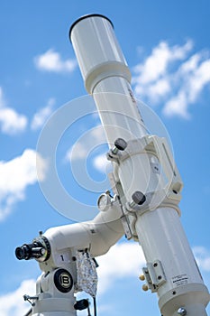 A professional refractor telescope mounted on a tripod