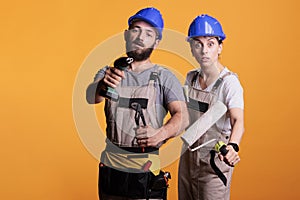 Professional renovators showing construction tools