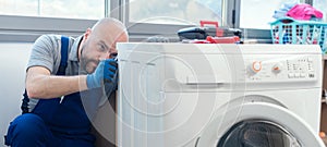 Professional repairman fixing a washer