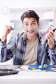 The professional repairman repairing computer in workshop