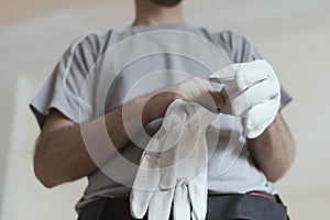 Professional repairman wearing protective gloves