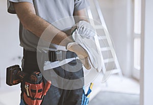 Professional repairman wearing protective gloves