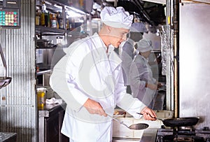 Professional responsible chef working in restaurant kitchen