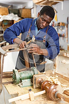 Professional restorer renewing vintage armchair