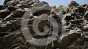 Professional rock climber on a cliff