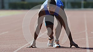 Professional runner starts his race from crouch start, desire to win, endurance