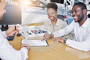 Professional sales agent and clients have friendly conversation in dealership