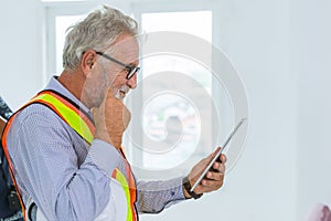 Senior engieer usign tablet and thinking