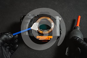 Professional sensor cleaning on a mirrorless camera, close-up photo photo