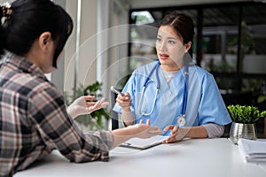 A professional and serious Asian female doctor is examining the symptoms of a patient