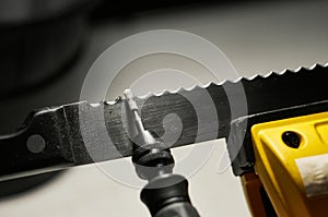 Professional serrated knife blade sharpening with a rotary tool. Macro