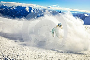 Professional skier at full speed ski downhill on fresh snow do carving in ski resort while training for competition in ski resort