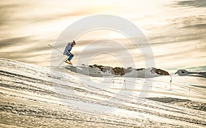 Professional skier performing acrobatic jump on downhill ride