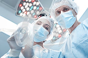 Professional skilled surgeons doing anaesthesia