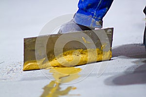 professional is skillfully filling the expansion joints with epoxy mortar using a trowel and putty knife, ensuring that the photo