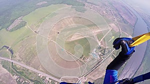 Professional skydiver fly above green flatland. Summer day. Landscape. Sport