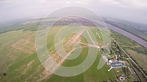 Professional skydiver fly in sky above green fields. Sunny day. Extreme. Scenery