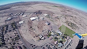 Professional skydiver parachuting in blue sky above Arizona. Sunny. Landscape