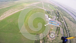 Professional skydiver prepare landing on green field. Summer. Landscape.