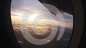 Professional skydiver shoot cloudy sky from porthole of airplane. Sunset. Sport.