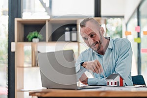 Professional and smart Caucasian male engineer having an online meeting with his team, explaining the building plan and