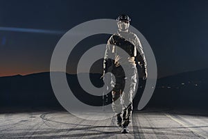 A professional soldier in full military gear striding through the dark night as he embarks on a perilous military