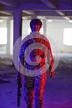 A professional soldier undertakes a perilous mission in an abandoned building illuminated by neon blue and purple lights