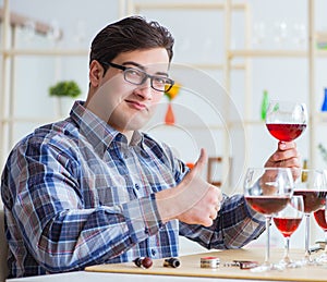 Professional sommelier tasting red wine