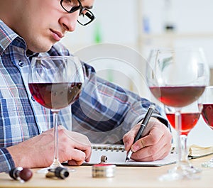 Professional sommelier tasting red wine