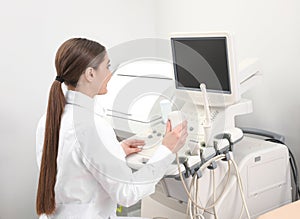 Professional sonographer using modern ultrasound machine