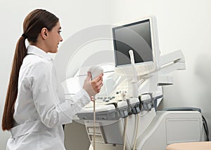 Professional sonographer using modern ultrasound machine