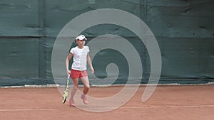 Professional sport, tennis player adolescent girl concentrating and focusing on game then hitting racket on ball at