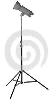 A professional studio flash, isolated on a white background. Photo-studio with lighting equipment. A long tripod.