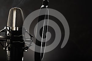 Professional studio microphone and pop filter. Monochrome image. Minimalism. There are no people in the photo. There is an empty
