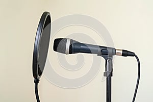 Professional studio microphone with pop shield on a stand isolated on white background. Nobody