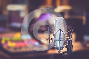 Professional studio microphone, recording studio, equipment in the blurry background