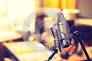 Professional studio microphone, recording studio, equipment in the blurry background